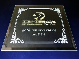 お取引先の会社のロゴマークと名前・40th anniversary・日付を彫刻した、周年祝いの贈り物用のガラス盾