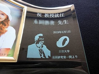 「祝教授就任 ○○先生」と「先生の似顔絵」を彫刻した、就任祝い用の写真立て