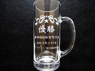 「優勝、大会名、開催日の日付、主催団体の名前」を側面に彫刻した、麻雀大会の優勝賞品用のビアジョッキ