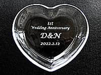 結婚記念日祝い用の小物入れ(1st wedding anniversary、旦那様と奥さまのイニシャル、結婚記念日の日付を、ハート形のガラス製小物入れに彫刻)