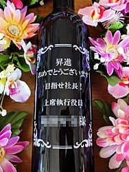 「昇進おめでとうございます。上席執行役員○○様」を彫刻した、昇進祝い用のワインボトル