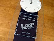 ロゴマークを前面ガラスに彫刻したヘアサロンの開店祝い用の掛け時計