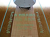 「祝病院長就任 ○○先生 ○○大学医学部ゴルフ部一同」を前面ガラスに彫刻した、病院長就任祝い用の振り子時計