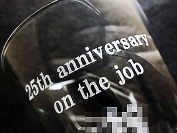 �i�N�Α��\���p�̃O���X���ʂɒ��������A�u25th anniversary on the job�v�̃N���[�Y�A�b�v�摜